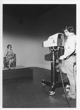 Photograph of an unidentified person being filmed