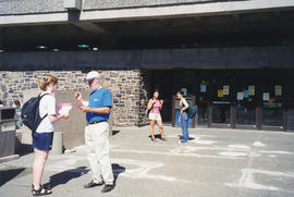 Photograph of Bill Maes assisting a passerby outside the Killam Web Café