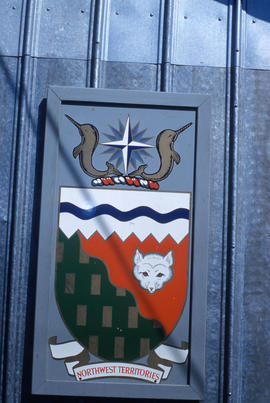 Photograph of the Northwest Territories crest on the side of a building in Frobisher Bay