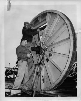 Photograph of cable foreman J.A. Caldwell and Jack Mutton checking gas pressure
