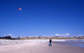 Photograph of two unidentified people flying a kite at Hirtle's Beach, near Kingsburg, Nova Scotia