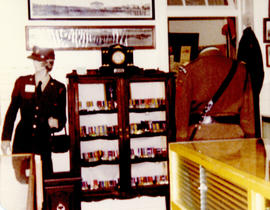 Photograph of a cabinet display of artifacts from the Royal Winnipeg Rifles Regiment