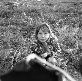 Photograph of Jessie sitting on the ground in Fort Chimo, Quebec