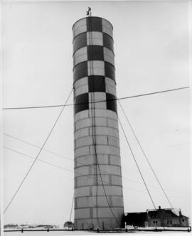 Photograph of an unidentified radio tower, checkered at top