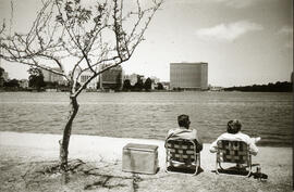 Photograph of two people sitting in lawn chairs looking at San Francisco Bay