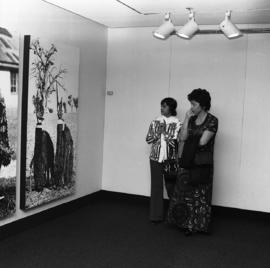 Photograph of unidentified people looking at a piece at the Dalhousie Art Gallery