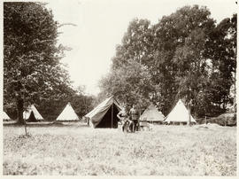 Photograph of Dr. John Stewart and officer in front of officer tents