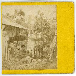 Photograph featuring Mrs. McNair and unidentified Indigenous people at the mission station in Dil...