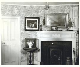 Photograph of a mantel in the Simeon Perkins house before its restoration, with a framed photogra...