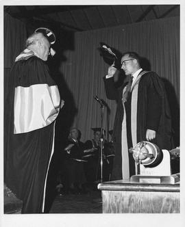 Photograph of Henry Hicks greeting an unidentified person at a convocation ceremony