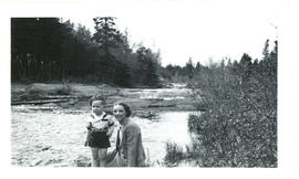 Photograph of Tommy Raddall, Jr. and Edith Raddall beside a river, taken near Porters Lake, Halif...