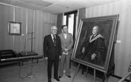 Photograph of Chester Stewart with a painting of himself