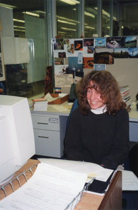 Photograph of Elizabeth Boyd at her desk in the Technical Services Department