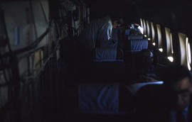 Photograph of passengers and cargo on an airplane
