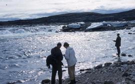 Photograph of Barbara Hinds and Frank Deloute standing by the water at Frobisher Bay, Northwest T...