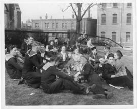 Photograph of servicemen and women celebrating VE-Day in a Halifax park