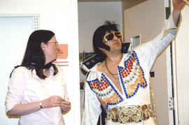 Photograph of Librarian Shelley McKibbon and Elvis impersonator striking a pose