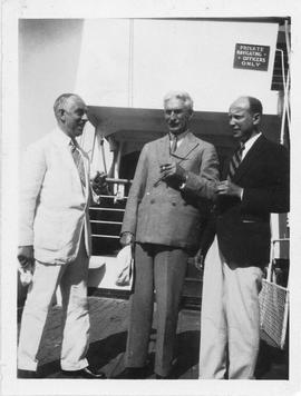 Photograph of Arthur Stanley MacKenzie and two unidentified people on a cruise ship