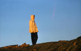 Photograph of Barbara Hinds standing on a hill near Frobisher Bay, Northwest Territories