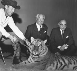 Photograph of Henry Hicks and G. I. Smith with a live tiger at the opening of the Student Union B...