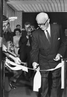 Photograph of H.P. McKeen cutting a ceremonial ribbon
