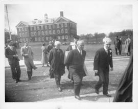 Photograph of several unidentified people walking across Studley campus