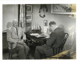 Photograph of Thomas Head Raddall and Ken Homer resting in the former's den between filming shots