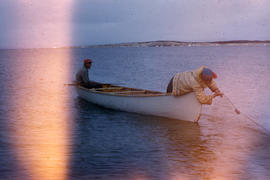 Photograph of two men fishing in a canoe near Fort Chimo, Quebec