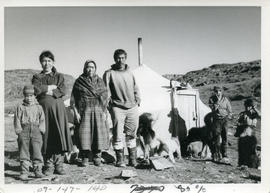 Photograph of a family standing outside of their house in Port Burwell, Northwest Territories