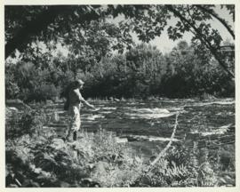 Photograph of Thomas Head Raddall fishing near Trout Rock at the foot of Lake Falls on the Mersey...