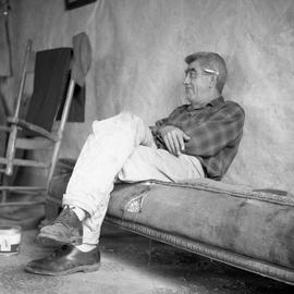 Photograph of Blackie McGowan sitting on a couch