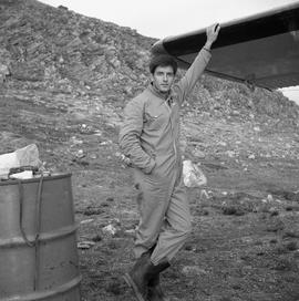 Photograph of Jean-Mari Girard standing with his hand on the wing of an airplane