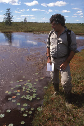 Photograph of Bill Freedman standing next to Murchyville bog, near Moose River, Nova Scotia