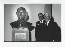 Photograph of Norman A. M. MacKenzie with a bust of himself and an unidentified man