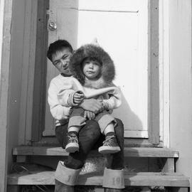 Photograph of Noah holding Billie Koneak on his lap in Fort Chimo, Quebec