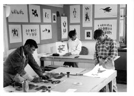 Photograph of three men making prints in Cape Dorset, Northwest Territories