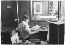 Photograph of an unidentified person in the master control room at CKDU Radio