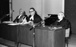Photograph of three unidentified people at a law award presentation