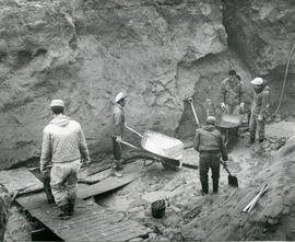 Photograph of five men digging into the permafrost in Fort Chimo, Quebec