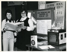 Photograph of Karen MacIntyre and Helen Patriquin demonstrating the Maritime Ambulatory Record Sy...