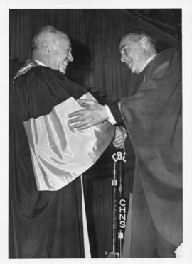 Photograph of Henry Hicks conferring an honorary degree on Dr. Ogden Glass