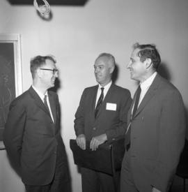 Photograph of three unidentified people at an event for the Dalhousie medical centennial