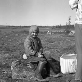 Photograph of Edward Koneak sitting on a rock in northern Quebec