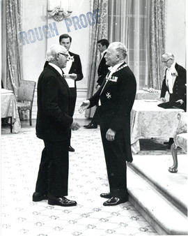 Photograph of Thomas Head Raddall shaking hands with Governor General Michener while being presen...