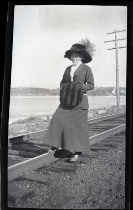 A woman stepping on the train track