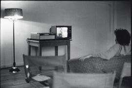 Photograph of a person watching television