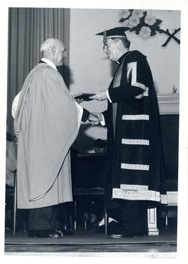 Photograph of Thomas Head Raddall receiving an honrary Doctor of Laws from Bishop W.E. Power at S...