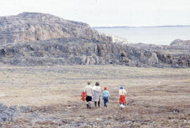 Photograph of four people walking in Cape Dorset, Northwest Territories