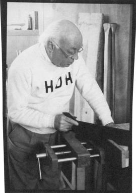 Photograph of Henry Hicks sawing wood