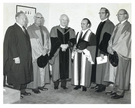 Photograph of Thomas Head Raddall and two other recipients of an honorary doctorate with the chan...